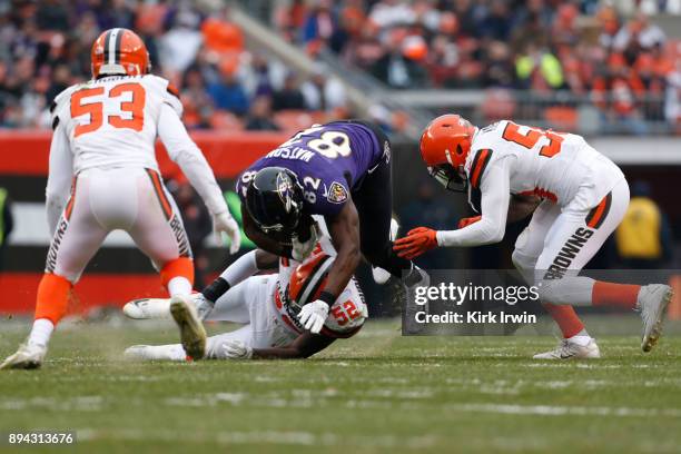 Benjamin Watson of the Baltimore Ravens is tackled by James Burgess of the Cleveland Browns in the first half at FirstEnergy Stadium on December 17,...