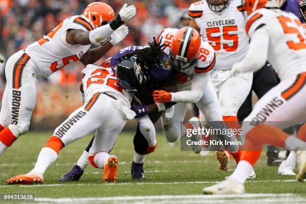 Alex Collins of the Baltimore Ravens collides with Christian Kirksey of the Cleveland Browns in the first half at FirstEnergy Stadium on December 17,...