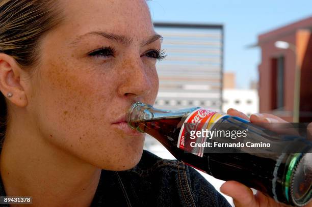 Girl drinking a coke.