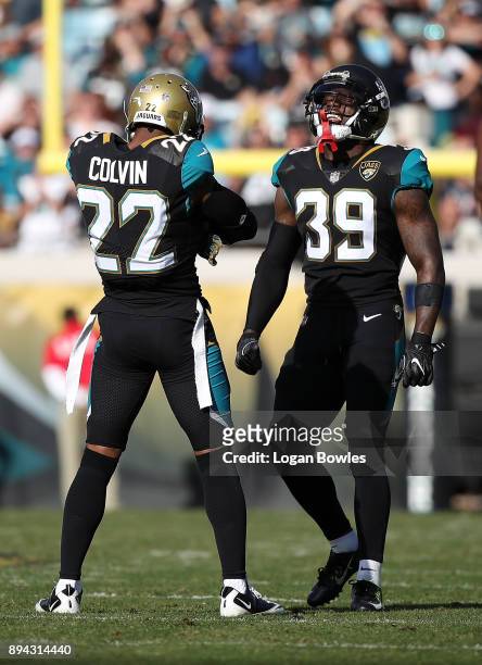 Aaron Colvin and Tashaun Gipson of the Jacksonville Jaguars celebrate a play on the field during the first half of their game against the Houston...