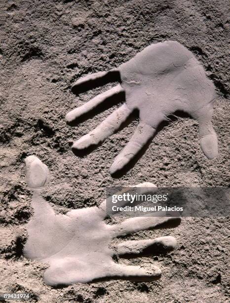 Hands tracks in cement powder.