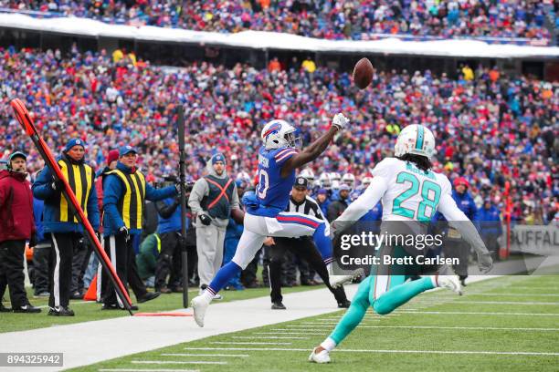 Deonte Thompson of the Buffalo Bills attempts to catch the ball as Bobby McCain of the Miami Dolphins attempts to defend him during the second...