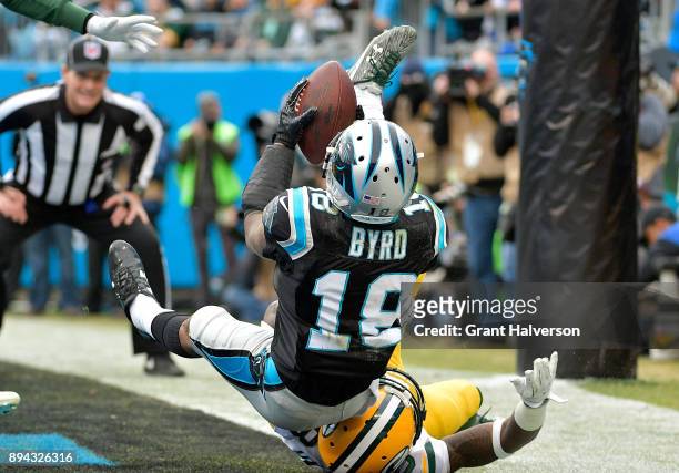 Damiere Byrd of the Carolina Panthers catches a touchdown pass against Josh Hawkins of the Green Bay Packers in the third quarter during their game...