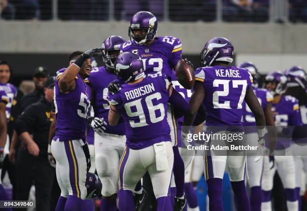Terence Newman of the Minnesota Vikings celebrates with teammate Brian Robison after intercepting the ball in the third quarter of the game against...