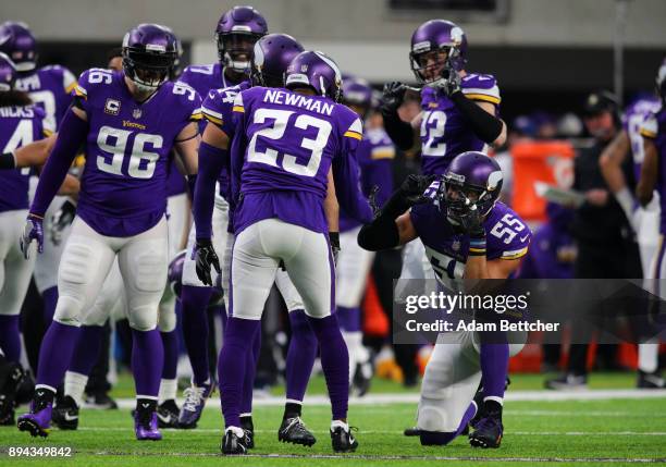 Terence Newman of the Minnesota Vikings celebrates with teammate Anthony Barr after intercepting the ball in the third quarter of the game against...