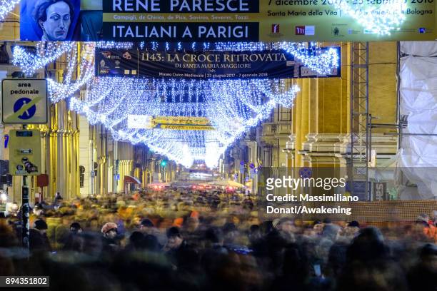 Tourists and locals walk in Via Indipendenza under the Christmas lights on December 17, 2017 in Bologna, Italy.