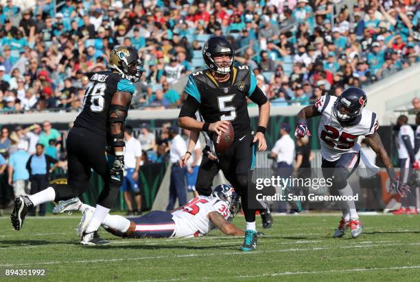 Blake Bortles of the Jacksonville Jaguars looks to pass the football in front of Kareem Jackson of the Houston Texans during the first half of their...