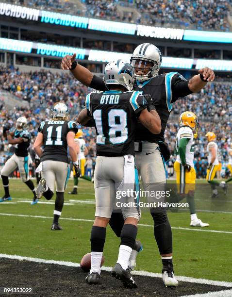 Damiere Byrd celebrates with teammate Cam Newton of the Carolina Panthers after a touchdown against the Green Bay Packers in the fourth quarter...