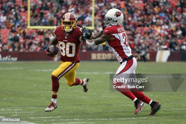 Wide receiver Jamison Crowder of the Washington Redskins is pushed out of bounds by cornerback Patrick Peterson of the Arizona Cardinals in the third...