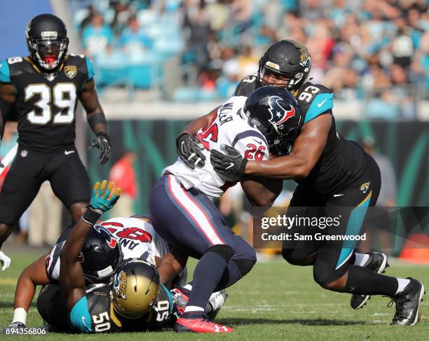Calais Campbell of the Jacksonville Jaguars tackles Lamar Miller of the Houston Texans during the second half of their game at EverBank Field on...