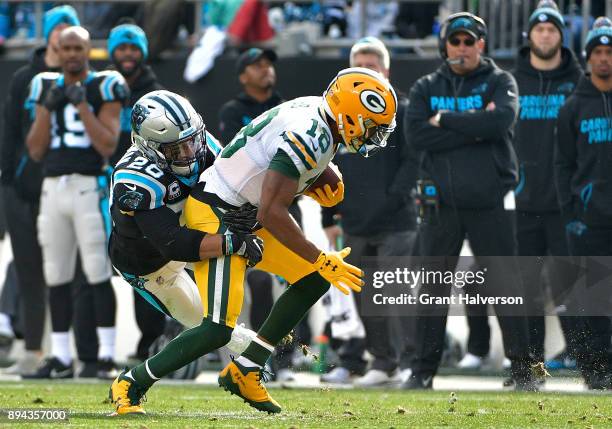 Kurt Coleman of the Carolina Panthers tackles Randall Cobb of the Green Bay Packers in the second quarter during their game at Bank of America...