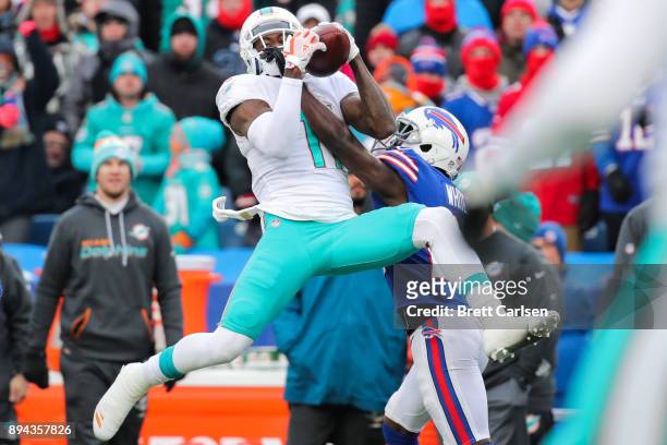 DeVante Parker of the Miami Dolphins attempts to catch the ball as Tre'Davious White of the Buffalo Bills attempts to break it up during the third...