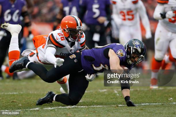 Derrick Kindred of the Cleveland Browns tackles Danny Woodhead of the Baltimore Ravens in the fourth quarter at FirstEnergy Stadium on December 17,...