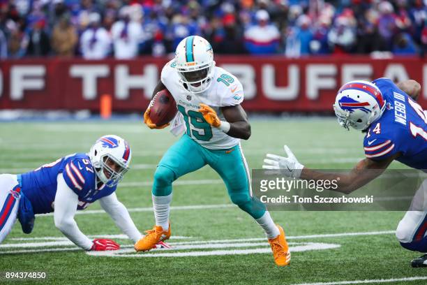 Jakeem Grant of the Miami Dolphins runs the ball as Lorenzo Alexander of the Buffalo Bills and Joe Webb of the Buffalo Bills attempt to tackle him...