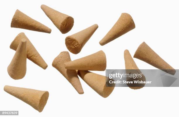 a pile and arrangement of sandalwood incense cones - sandalwood fotografías e imágenes de stock