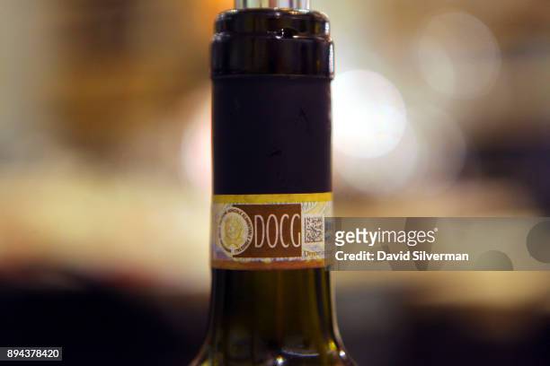 Label is seen on the neck of a bottle of red Italian wine at the Rimessa Roscioli restaurant on December 8, 2017 in Rome, Italy. The letters DOCG on...