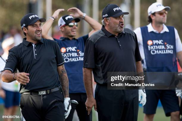 Angel Cabrera and Angel Cabrera Jr. Of Argentina react to a putt on the 18th green during the final round of the PNC Father/Son Challenge at The...