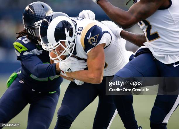 Wide receiver Cooper Kupp of the Los Angeles Rams is tackled by cornerback Shaquill Griffin of the Seattle Seahawks as he rushes during the game at...