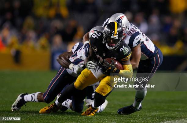 Le'Veon Bell of the Pittsburgh Steelers carries the ball against Trey Flowers of the New England Patriots in the second quarter during the game at...