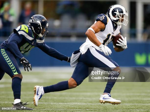 Wide receiver Robert Woods of the Los Angeles Rams escapes cornerback Byron Maxwell of the Seattle Seahawks during the 2nd quarter of the game at...