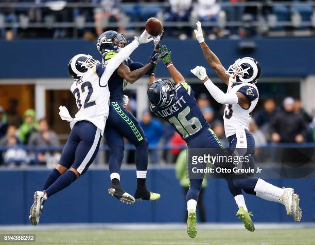 Cornerback Troy Hill of the Los Angeles Rams knocks away a pass as wide receiver Paul Richardson of the Seattle Seahawks and Tyler Lockett try to...