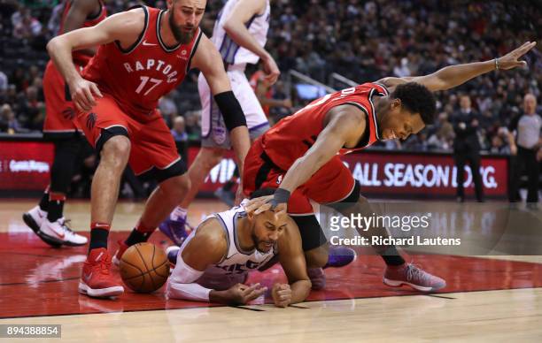 In second half action, Sacramento Kings guard Garrett Temple gets the worst of the scramble for the ball with Toronto Raptors guard Kyle Lowry and...