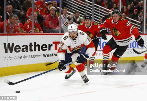 Alexander Petrovic of the Florida Panthers looks to pass in front of John Hayden of the Chicago Blackhawks at the United Center on December 12, 2017...