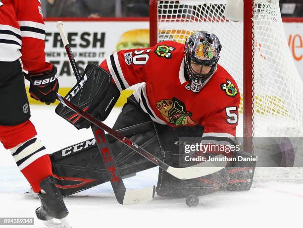 Corey Crawford of the Chicago Blackhawks makes a save against the Florida Panthers at the United Center on December 12, 2017 in Chicago, Illinois.