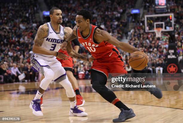 In first half action, Toronto Raptors guard DeMar DeRozan drives around Sacramento Kings guard George Hill The Toronto Raptors took on the Sacramento...