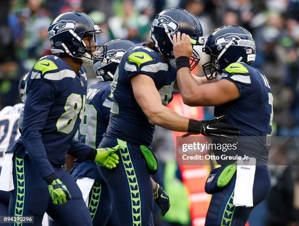 Tight end Luke Willson of the Seattle Seahawks is greeted by Russell Wilson after scoring a touchdown during the third quarter of the game against...