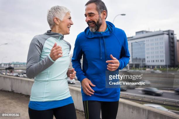 people jogging outdoors - 50 59 years stock pictures, royalty-free photos & images