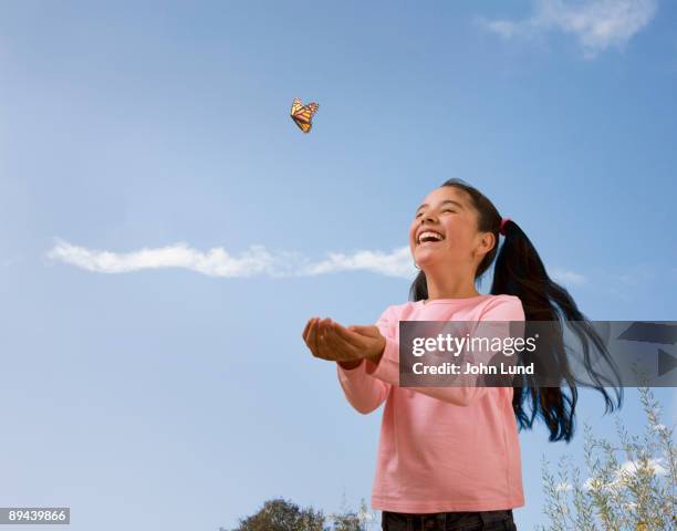 hispanic girl and butterfly - releasing butterfly stock pictures, royalty-free photos & images