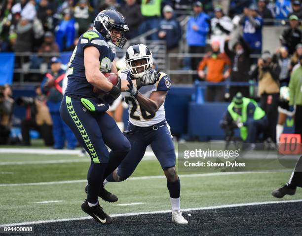 Tight end Luke Willson of the Seattle Seahawks scores a touchdown against safety Lamarcus Joyner of the Los Angeles Rams during the third quarter of...