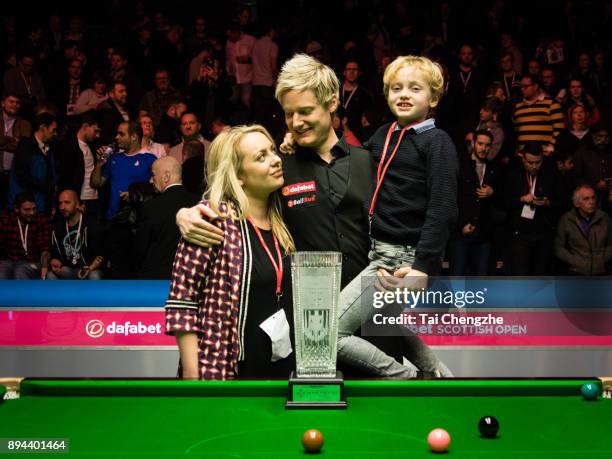 Neil Robertson of Australia celebrates with his wife and son after winning the final match against Cao Yupeng of China on day seven of the 2017...