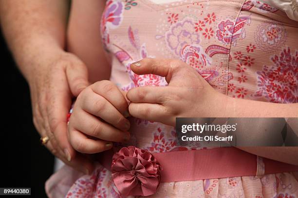 Johann Harrison touches her daughter India Harrison's hand outside the Law Society following a ruling that Corby Council have been found to be...