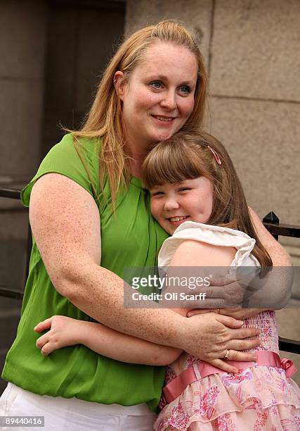 Johann Harrison embraces her daughter India Harrison, age 9, outside the Law Society following a ruling that Corby Council have been found to be...