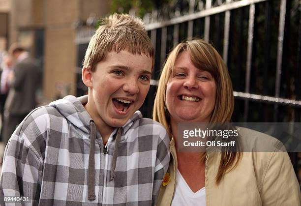 Dylan South celebrates with his mother Audrey Barfield outside the High Court following a ruling that Corby Council have been found to be negligent...
