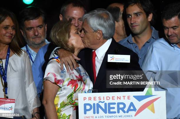 Chilean presidential candidate Sebastian Pinera , surrounded by his family, kisses his wife Cecilia Morel after giving his victory speech outside a...