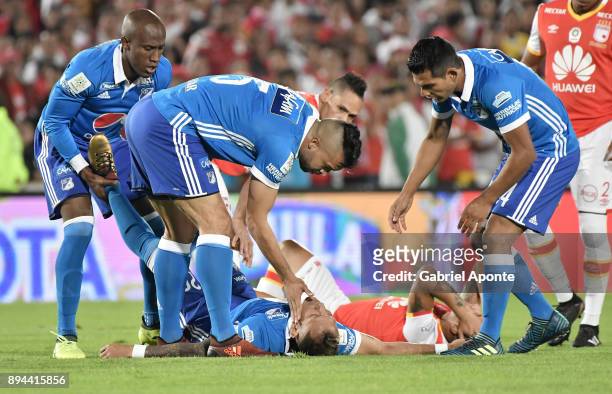 Juan Guillermo Dominguez of Millonarios lies on the ground after being injured during the second leg match between Millonarios and Santa Fe as part...
