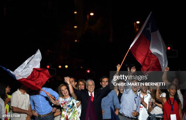 Chilean presidential candidate Sebastian Pinera and his wife Cecilia Morel wave Chilean flags as they celebrate his victory with family and...