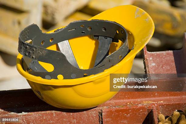 close up of hard hat at construction site - building site accidents stock pictures, royalty-free photos & images