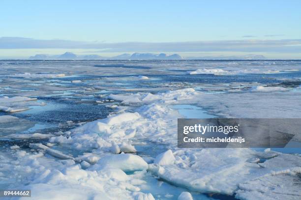 packed ice tundra melts in the sun - north pole stock pictures, royalty-free photos & images
