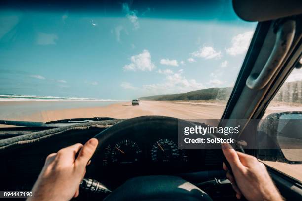 point of view driving on fraser island - beach car stock pictures, royalty-free photos & images
