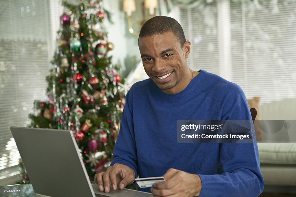 Man at computer with christmas tree