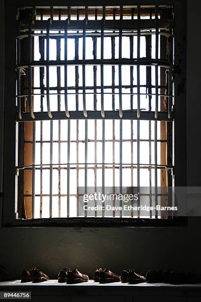 Shoes left behind by convicts lay under a window in the main prison block of Alcatraz Island on June 13, 2009 in San Francisco, United States....