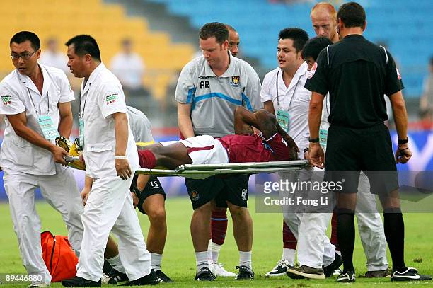 Luis Boa Morte of West Ham United is stretchered off the pitch after injuring his knee during the Barclays Asia Trophy pre-season friendly match...