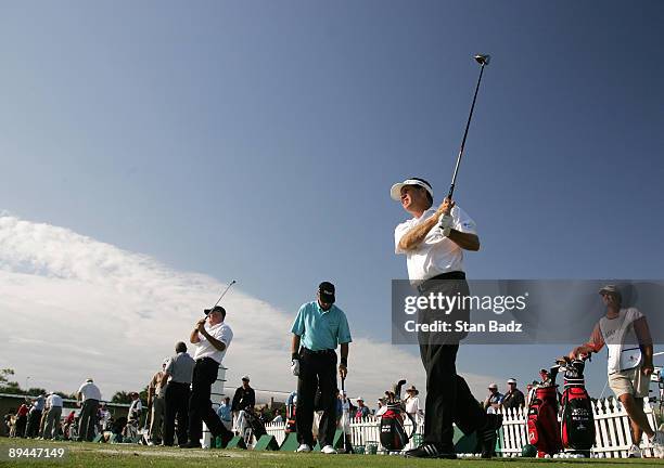 Mitch Adcock, far right, hits balls on the practice range during the final round of the Allianz Championship held on February 10, 2008 at The Old...