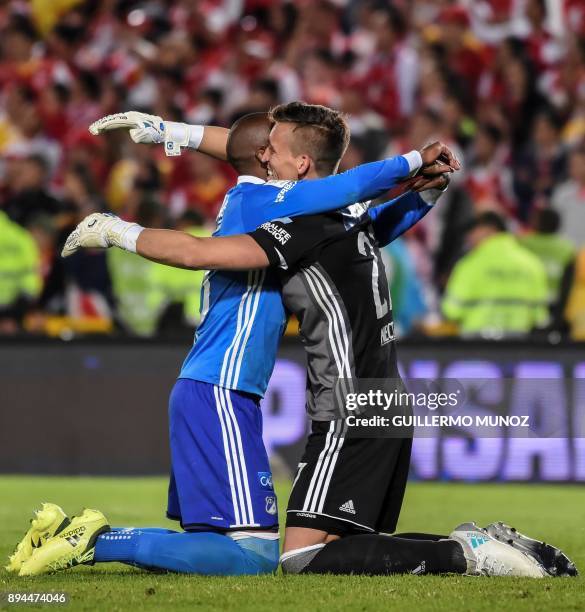 Millonarios defender Felipe Banguero celebrates with his teammate goalkeeper Nicolas Vikonis of Uruguay after winning their Colombian Football League...