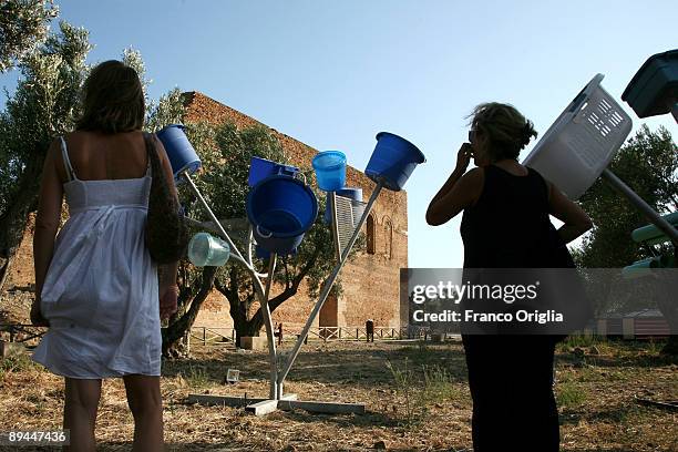 Visitors view artworks of the 'Alternative Landscape' exhibition by American installation artist Dennis Oppenheim on display at Scolacium...