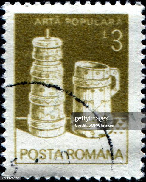 Stamp printed in Romania, 1982 shows Butter churn, wooden bucket, from Moldavia, folk art series.